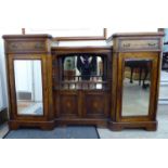 A late Victorian figured walnut, inverted breakfront display cabinet with a stepped top,