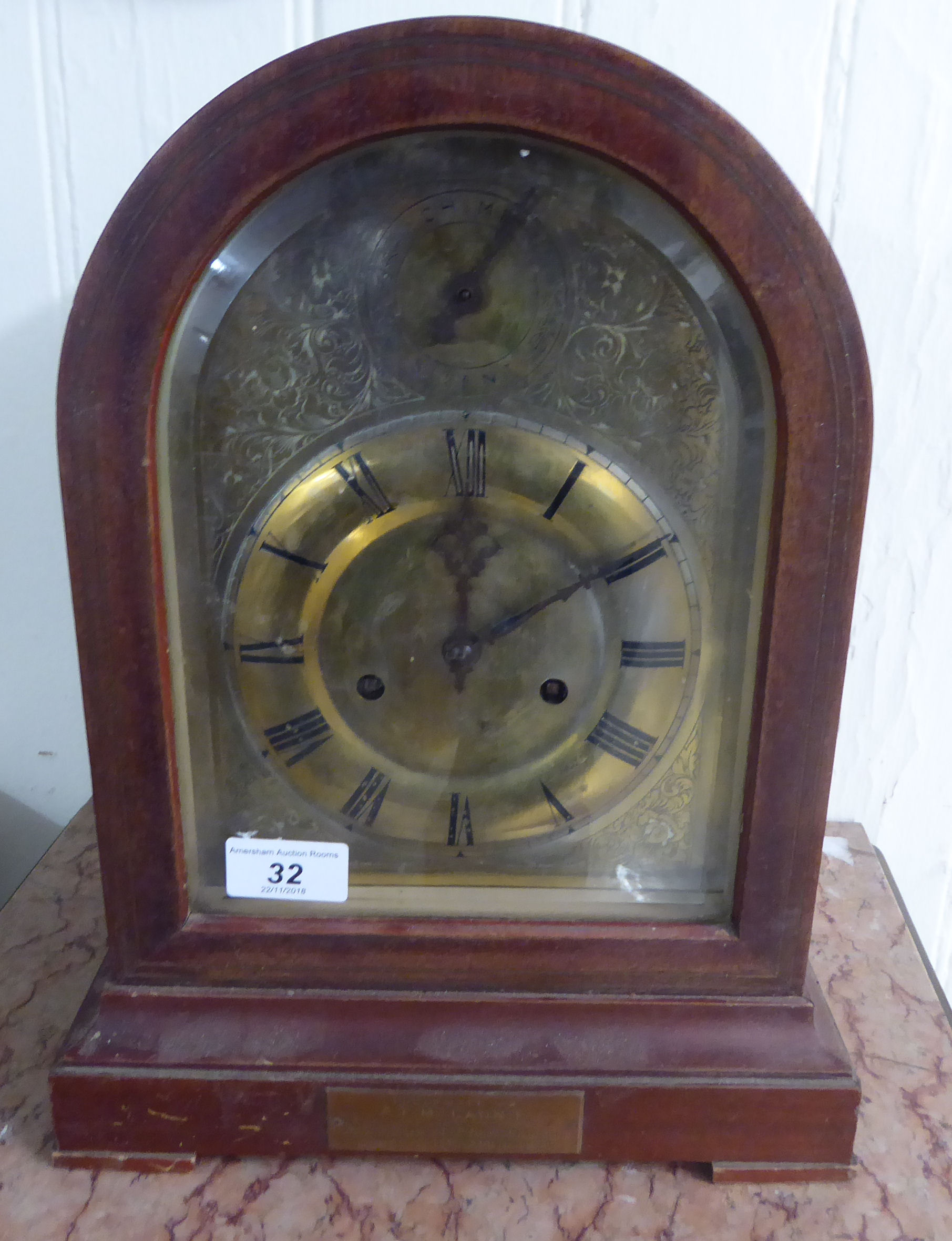 An early 20thC mahogany cased bracket clock, having a round arch top and straight sides,