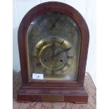 An early 20thC mahogany cased bracket clock, having a round arch top and straight sides,