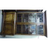 An early 19thC style mahogany cabinet bookcase, enclosed by a pair of three-quarter height, arched,