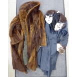 A lady's blue leather and fur trimmed, knee length coat approx.