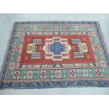 A Persian rug with stylised designs bordered by foliage on a multi-coloured ground 74'' x 104''
