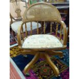 A modern American style, oak framed, round back desk chair, incorporating a woven, split cane panel,