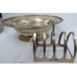 A silver oval sweet dish with decoratively pierced sides and a flared, bead border,