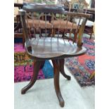 An early 20thC mahogany framed, round, spindled back desk chair,