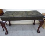 An early 20thC rectangular stool with a button upholstered green hide seat,