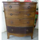 A 20thC Georgian style mahogany bow front chest with four graduated drawers and iron ring handles,