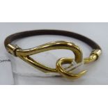 A Hermes 14ct gold mounted and brown hide bracelet 11