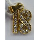 An 18ct gold diamond set pendant '18' 11