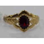 A 9ct gold ring, set with a garnet,