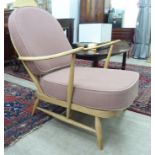 An Ercol light coloured beech framed Windsor hoop and spindle back open arm chair,