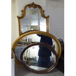 Three dissimilar modern mirrors: to include one oval,