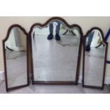 An Edwardian bevelled, arched triptych mirror,