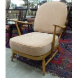 An Ercol light coloured beech framed Windsor hoop and spindle back open arm chair, raised on short,