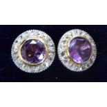 A pair of 18ct gold mounted earrings with a central amethyst,