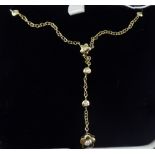 An 18ct gold necklace with circular and floral diamond set ornament by Pascal,