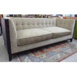 A modern mushroom and blackberry coloured fabric part button upholstered three person box settee