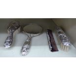 A Victorian style four piece silver mounted dressing table set, embossed with marks,