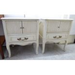 A pair of modern Georgian style washed cream painted, serpentine front bedside cabinets,