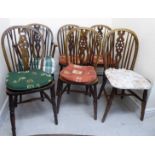 A set of four early 20thC Windsor beech and elm framed hoop and spindle back chairs with wheel