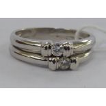 A white gold coloured metal twin band ring,