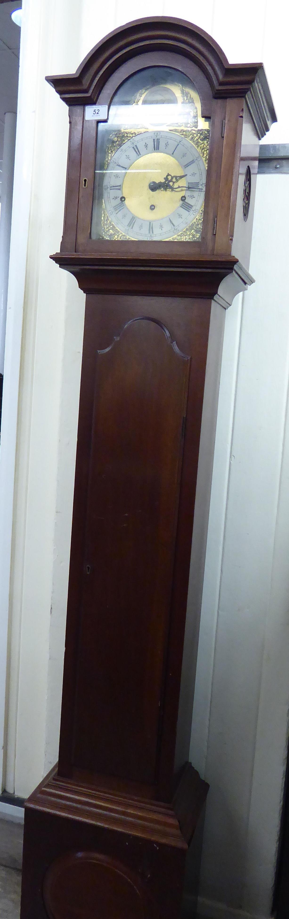 A mid 20thC mahogany cased grandmother clock, the hood with an arched top, over a straight trunk,