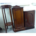 An Edwardian satin mahogany inlaid pot cupboard, enclosed by a full-height panelled door,