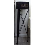 A modern black painted steel jardiniere stand, overpainted with scrolls and garland ornament,