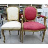 A modern reproduction of a French painted gilt showwood framed elbow chair,