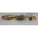 Three dissimilar 9ct gold coloured metal dress rings, variously set with opals,