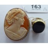 A 9ct gold oval framed, carved, cameo profile portrait brooch; and a gold coloured metal ring,