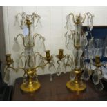 A pair of lacquered brass and cut clear crystal table candelabra of tiered form,
