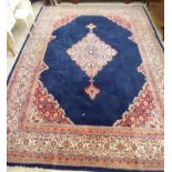 A Persian carpet with a central diamond medallion in a multi-guard border on a blue ground 106'' x