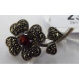 A silver marcasite and red stone set floral brooch 11
