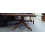 A modern Regency style figured and crossbanded walnut coffee table, raised on a reeded,