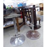 A pair of modern chromium plated steel bar stools with height adjustable, moulded,