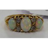 An 18ct gold claw set opal and diamond ring 11