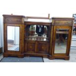 A late Victorian figured walnut, inverted breakfront display cabinet with a stepped top,