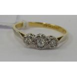 An 18ct gold three stone diamond ring 11