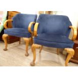 A pair of 1930s tub style chairs with laminated beech open arms, upholstered in Royal Blue dralon,