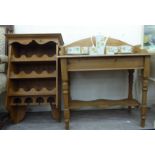 An early 20thC waxed pine washstand with a low gallery, raised on turned legs,