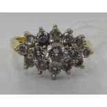 An 18ct gold claw set 15 stone diamond cluster ring 11