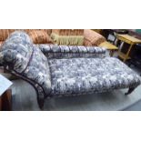 A late Victorian chaise longue with a scrolled end and low back,