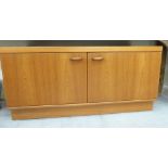 A 1970/80s teak cabinet with two doors,