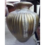 A modern gilded and overpainted pottery terrace vase of flute moulded, squat,