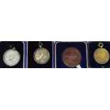 Two silver and one silver gilt medallion; and another in bronze,