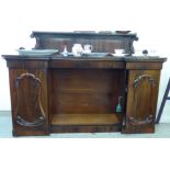 A William IV rosewood chiffonier with a panelled upstand and brass gallery,