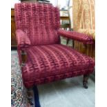 A late Victorian oak framed library chair, having a square back, level open arms and a deep,