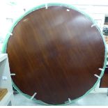 A modern crossbanded mahogany table top,