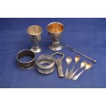 White metal items to include: egg cups, napkin rings, condiment spoons and others,